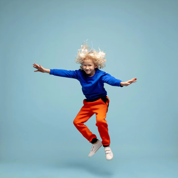 happy-curly-boy-isolated-blue-studio-background-looks-happy-cheerful-sincere-copyspace-childhood-education-emotions-concept_155003-46394
